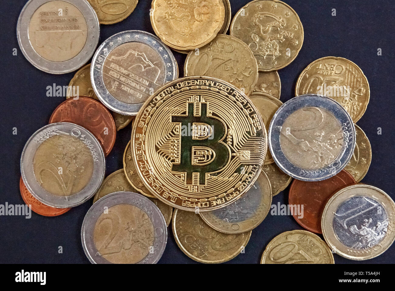 Physical version of Bitcoin, new virtual money . Golden symbolic coins of  bitcoins on Euro coins. Exchange bitcoin. Concept worldwide cryptocurrency  Stock Photo - Alamy