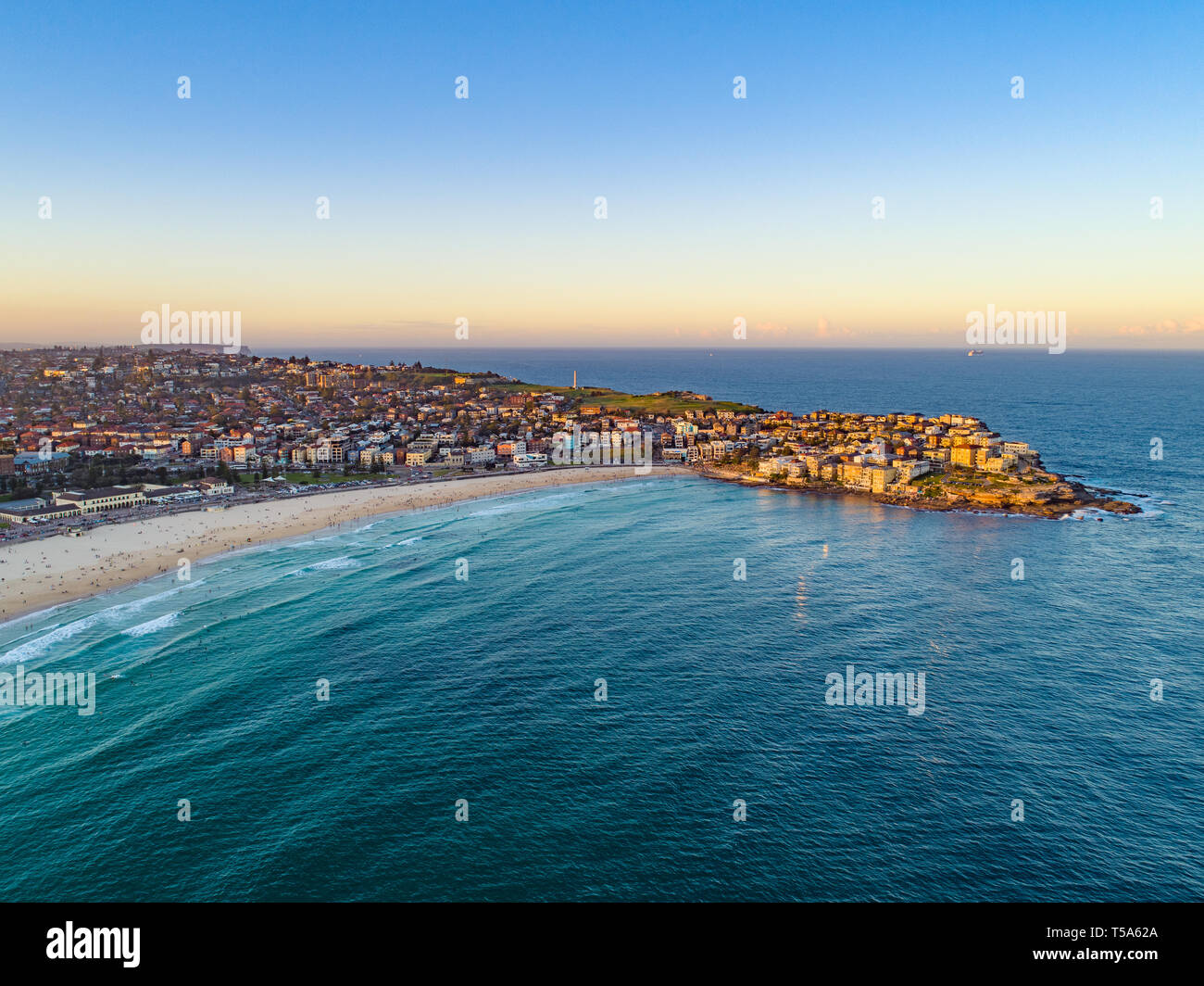 Bondi Beach Drone Shot at Sunset with Sydney CBD in background at Sunset Stock Photo