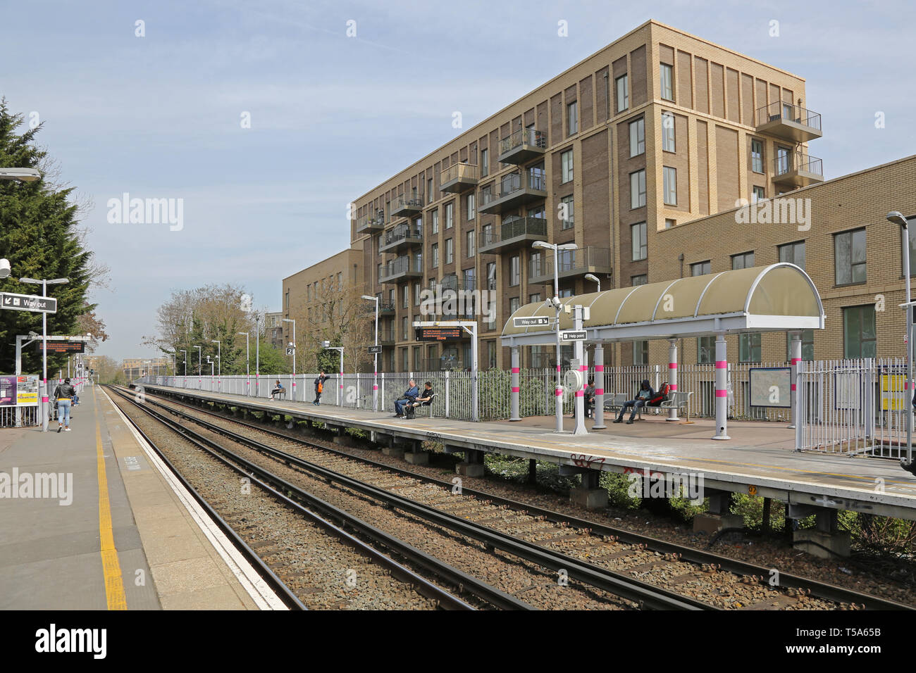 Refurbished platforms and tracks Catford Station, South London, UK. Shows new apartment block beyond. Stock Photo