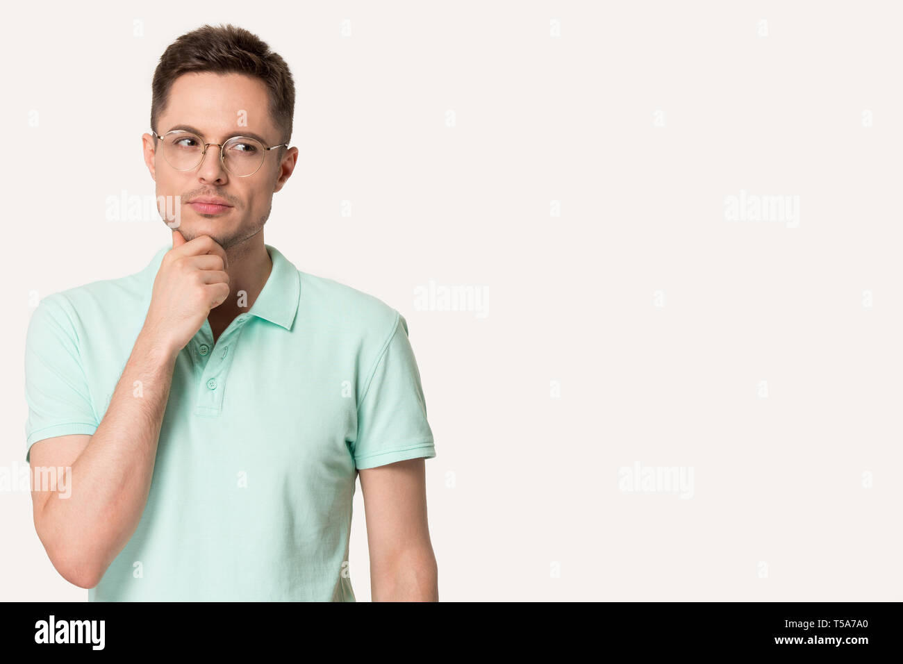 Thoughtful man in glasses touch chin making decision Stock Photo