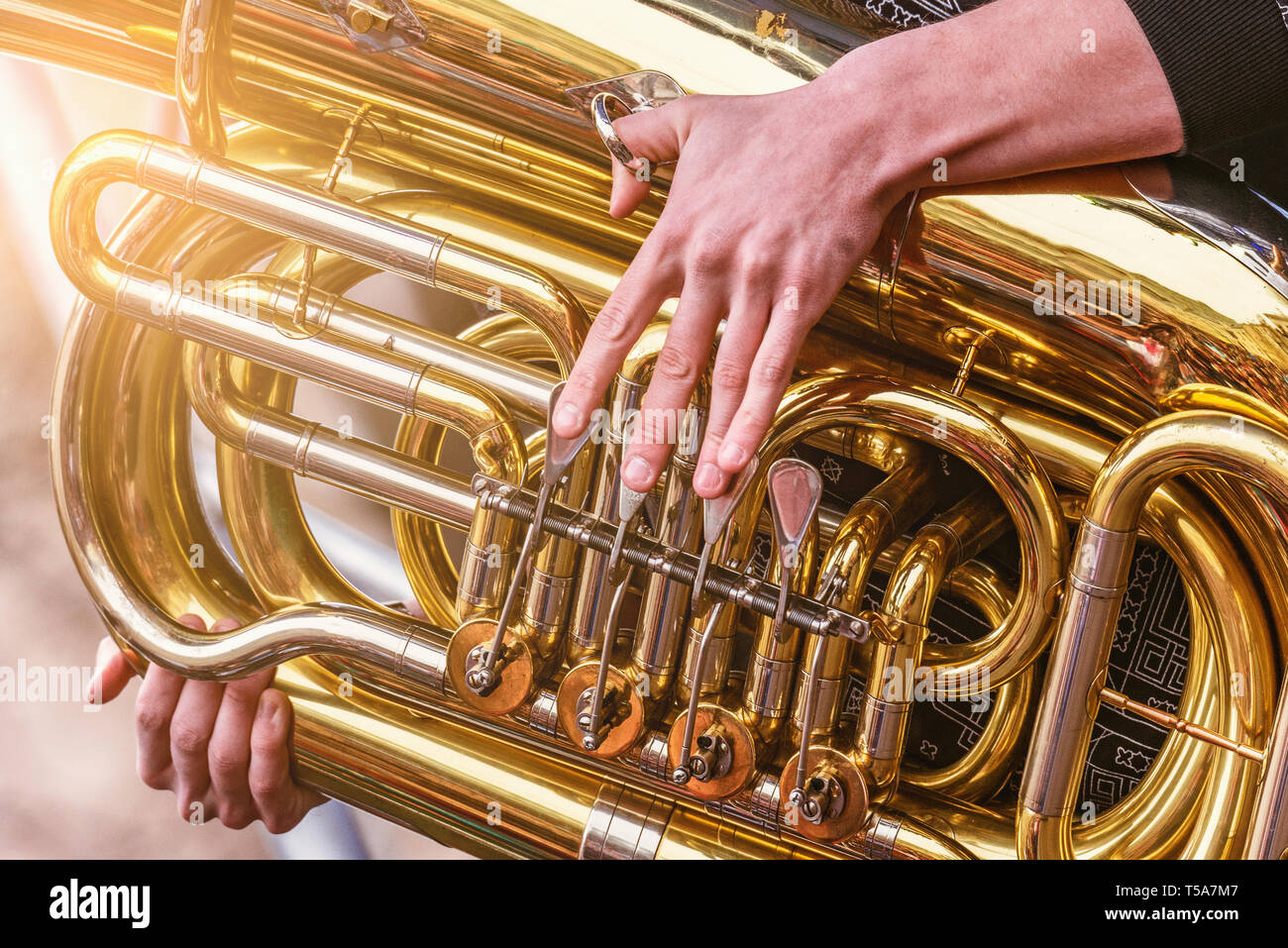 Musician playing tuba at evening time on the city square Stock Photo ...