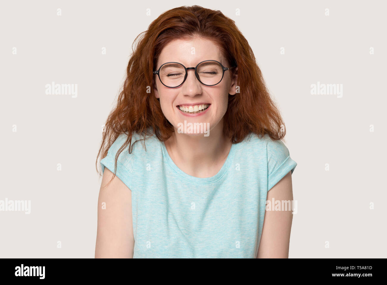 Happy redhaired girl in glasses laugh at funny joke Stock Photo Alamy
