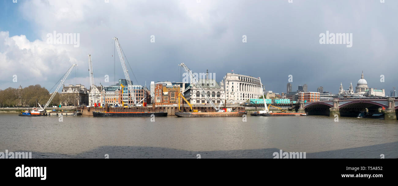 A panoramic images of cranes on barges on the River Thames working on the installation the new Super Sewer on the Albert  Embankment in London. Stock Photo