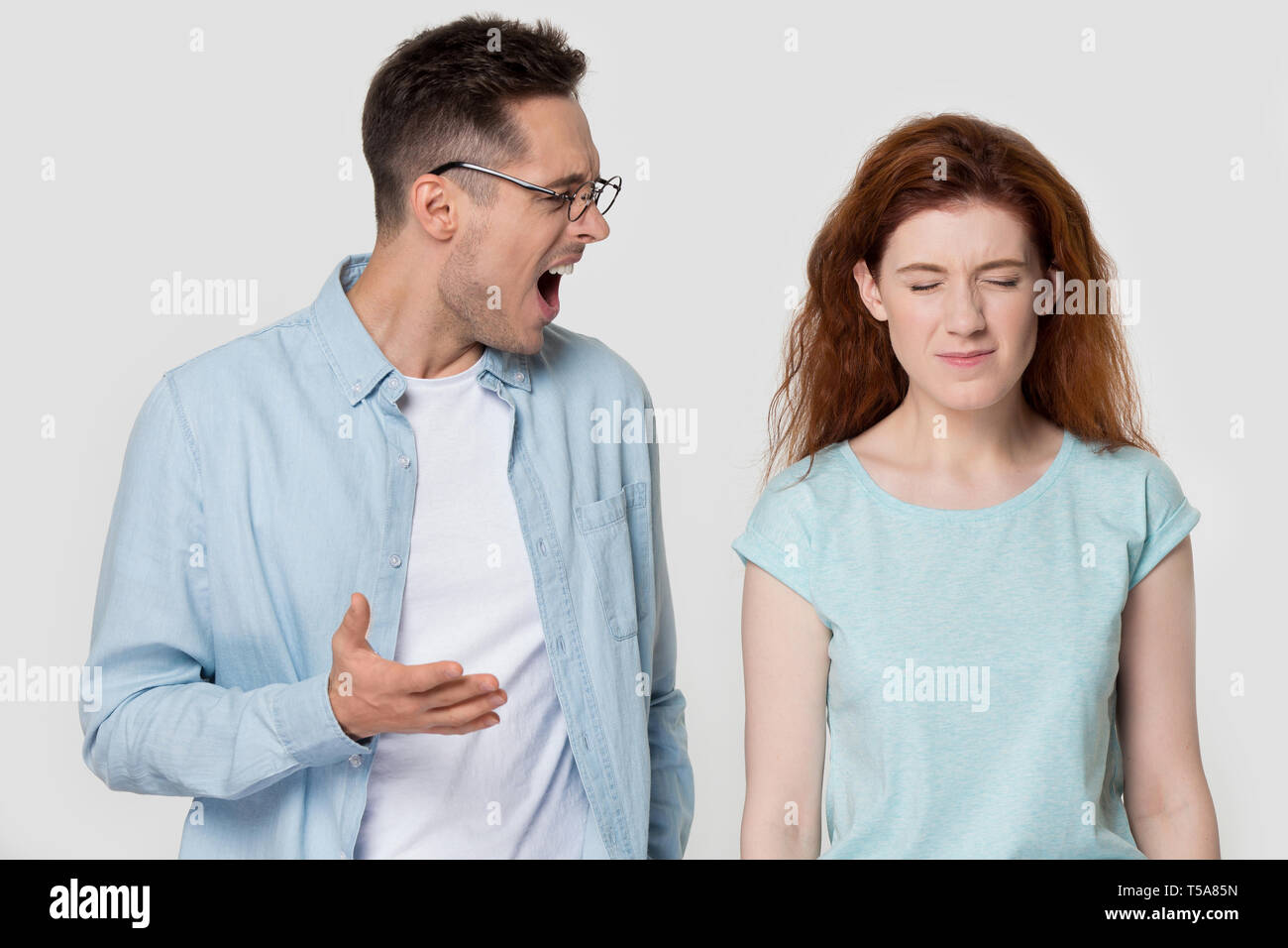 Furious man argue with girlfriend shouting at her Stock Photo