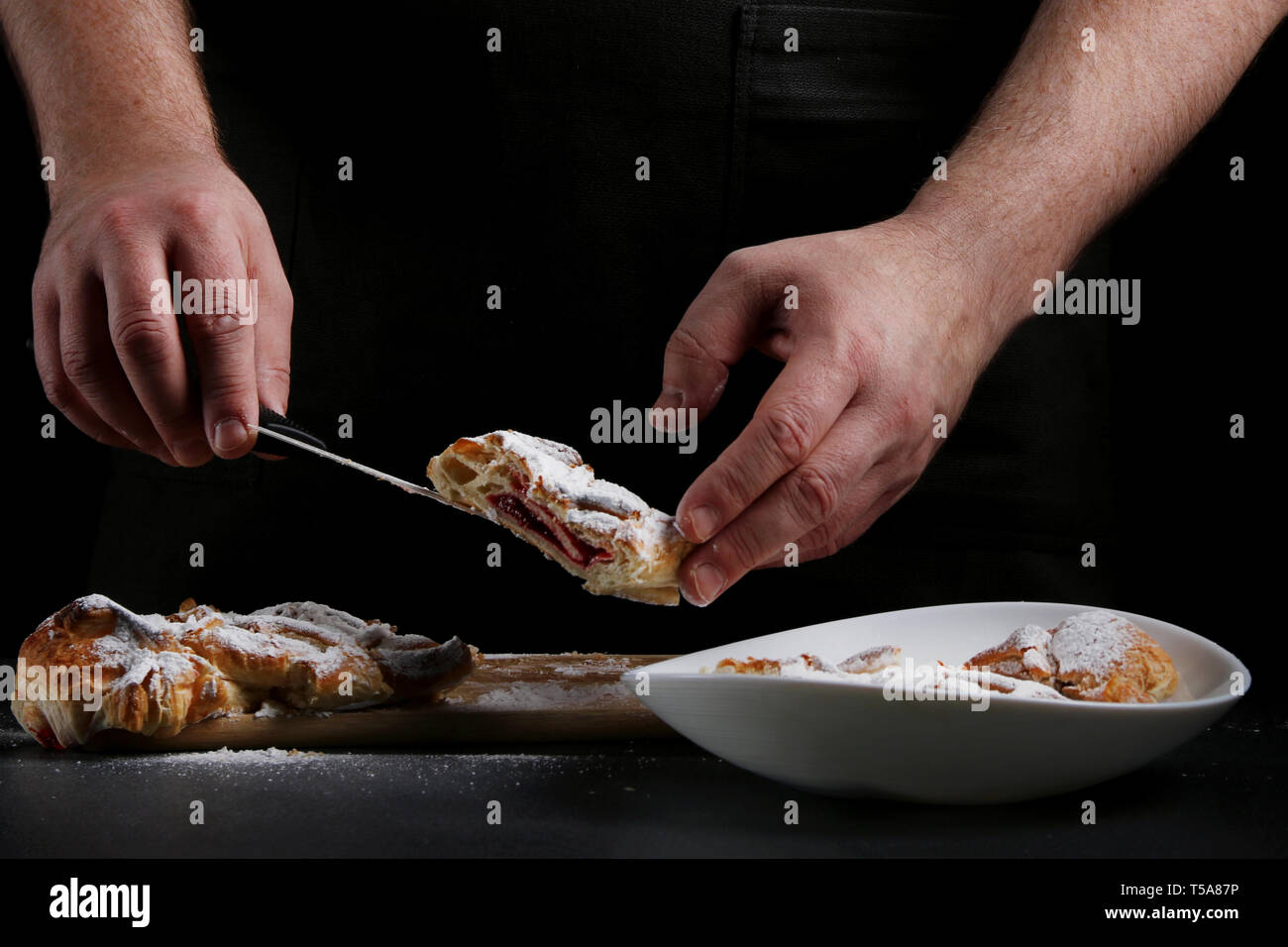 baker decorating on dark background. recipe concept. Stock Photo
