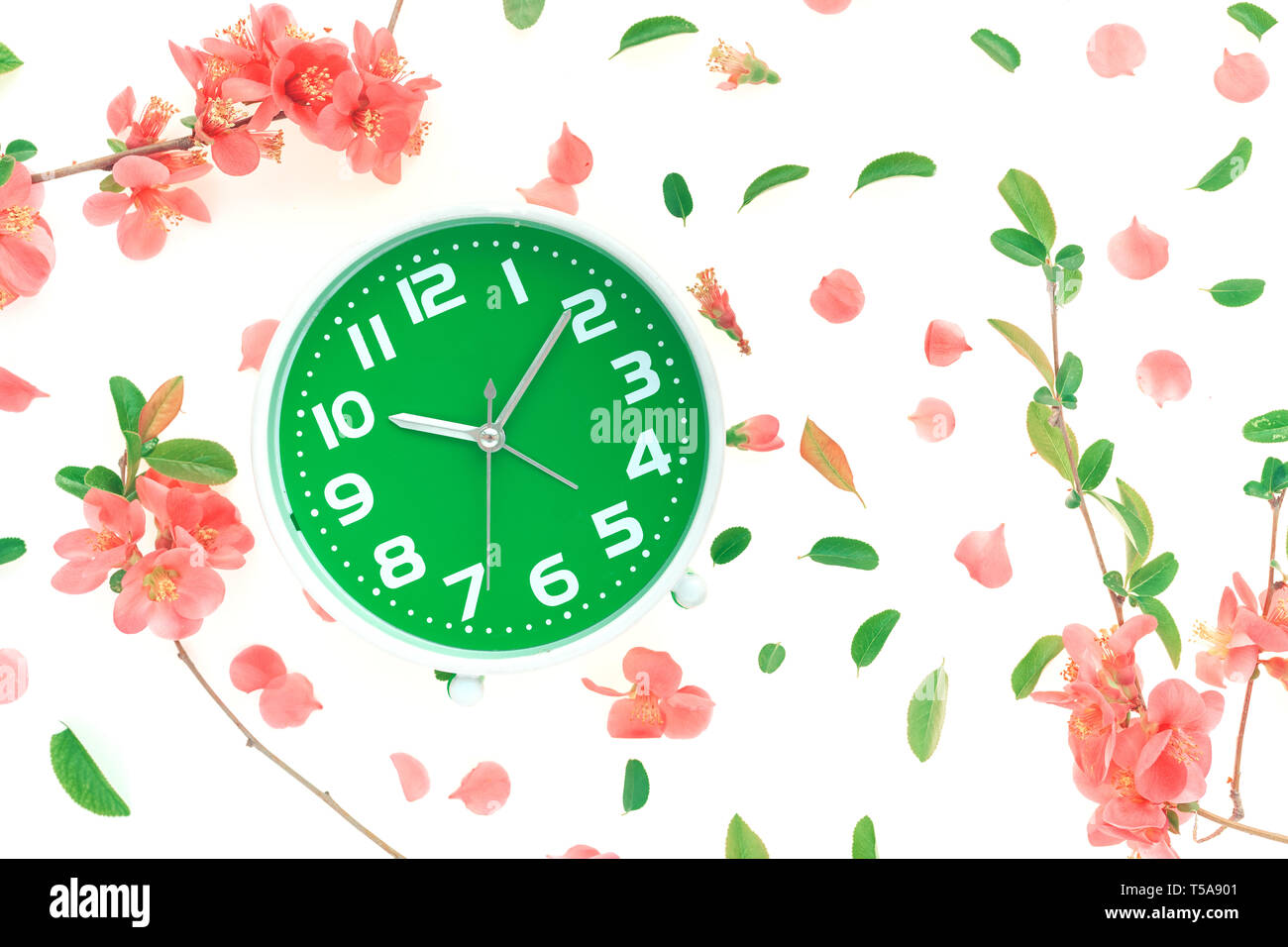 Vintage alarm clock flat lay with colorful springtime floral decoration ...