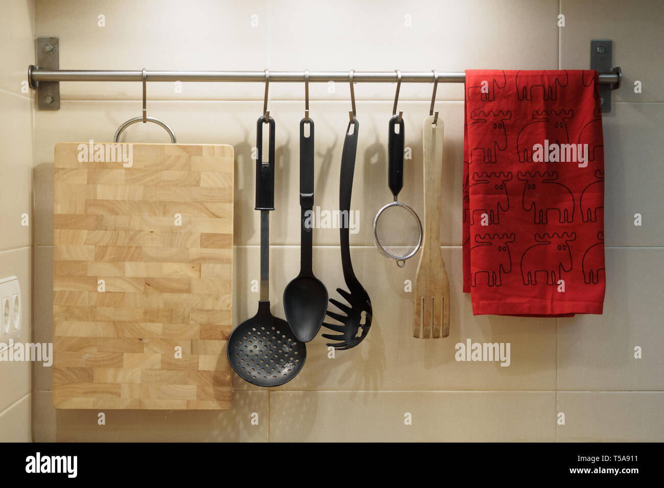kitchen utensils hanging on the wall Stock Photo Alamy