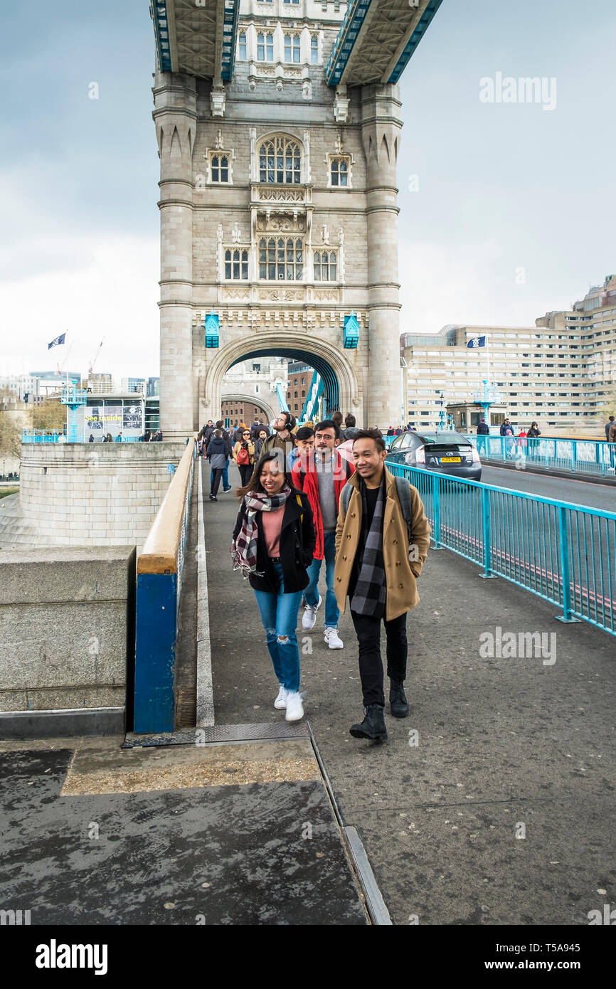 Pedestrians walking across Tower Bridge in London Stock Photo - Alamy