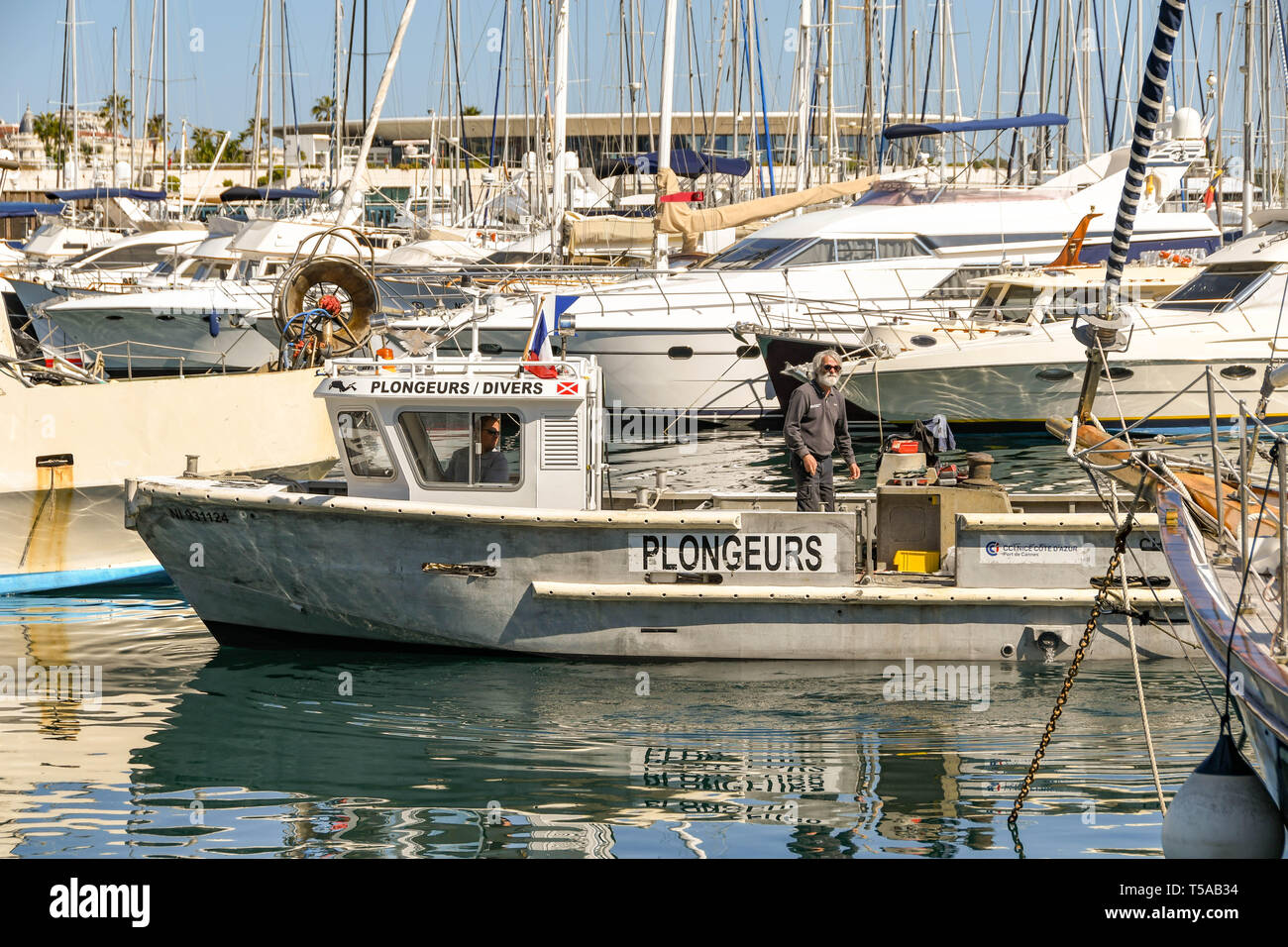 CANNES, FRANCE - APRIL 2019: Diving boat with people on board arriving in the harbour in Cannes. Stock Photo