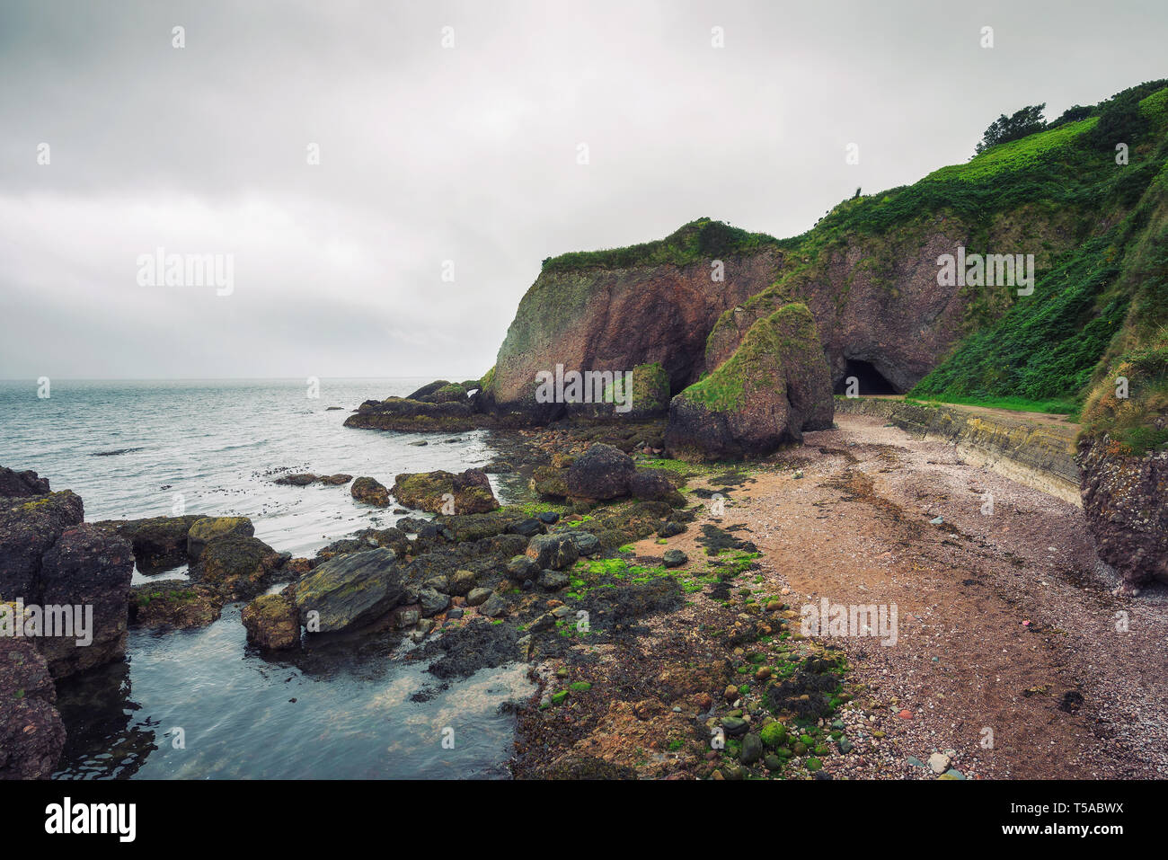 Entry to the Cushendun Cave in Northern Ireland Stock Photo