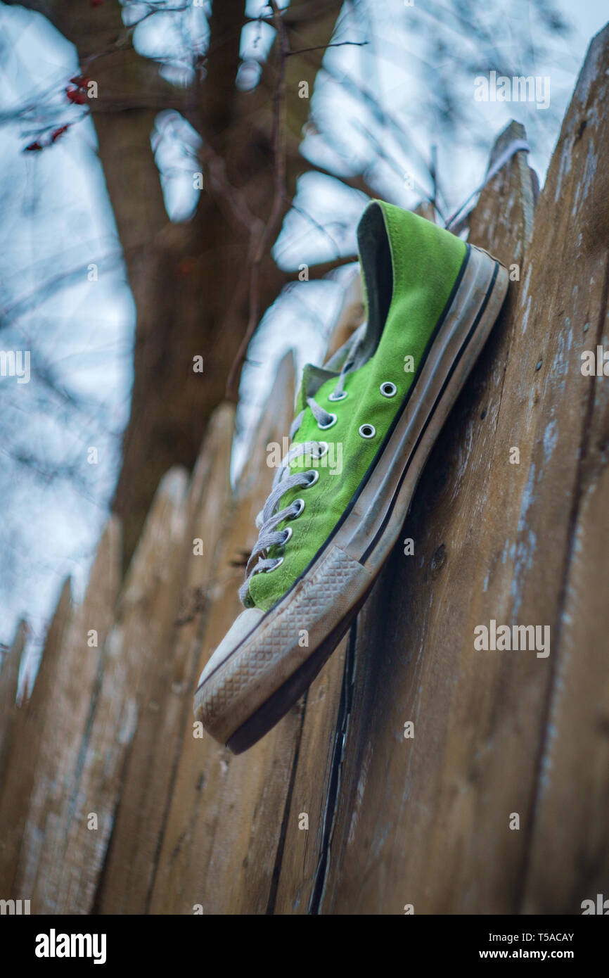 Old smelly worn classic sneaker lost on city street Stock Photo - Alamy