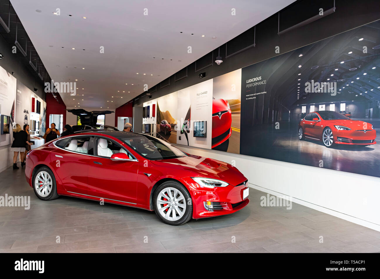 HONOLULU HAWAII USA - APRIL 2, 2019: Tesla Motors showroom with the Tesla Model S in the foreground. Tesla Motors is an industry leading designer and  Stock Photo