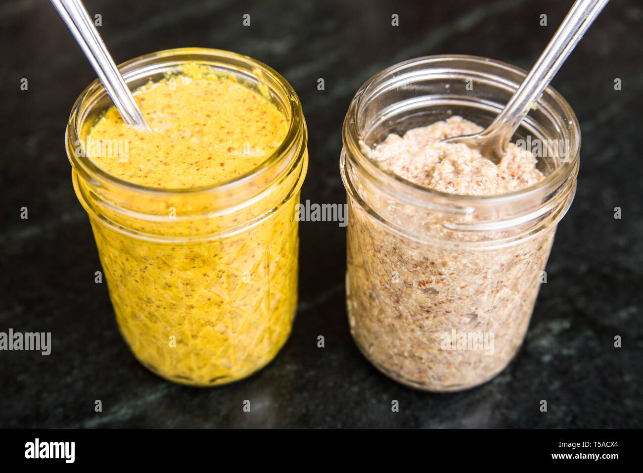 Home-canned yellow mustard and a Bavarian sweet mustard Stock Photo