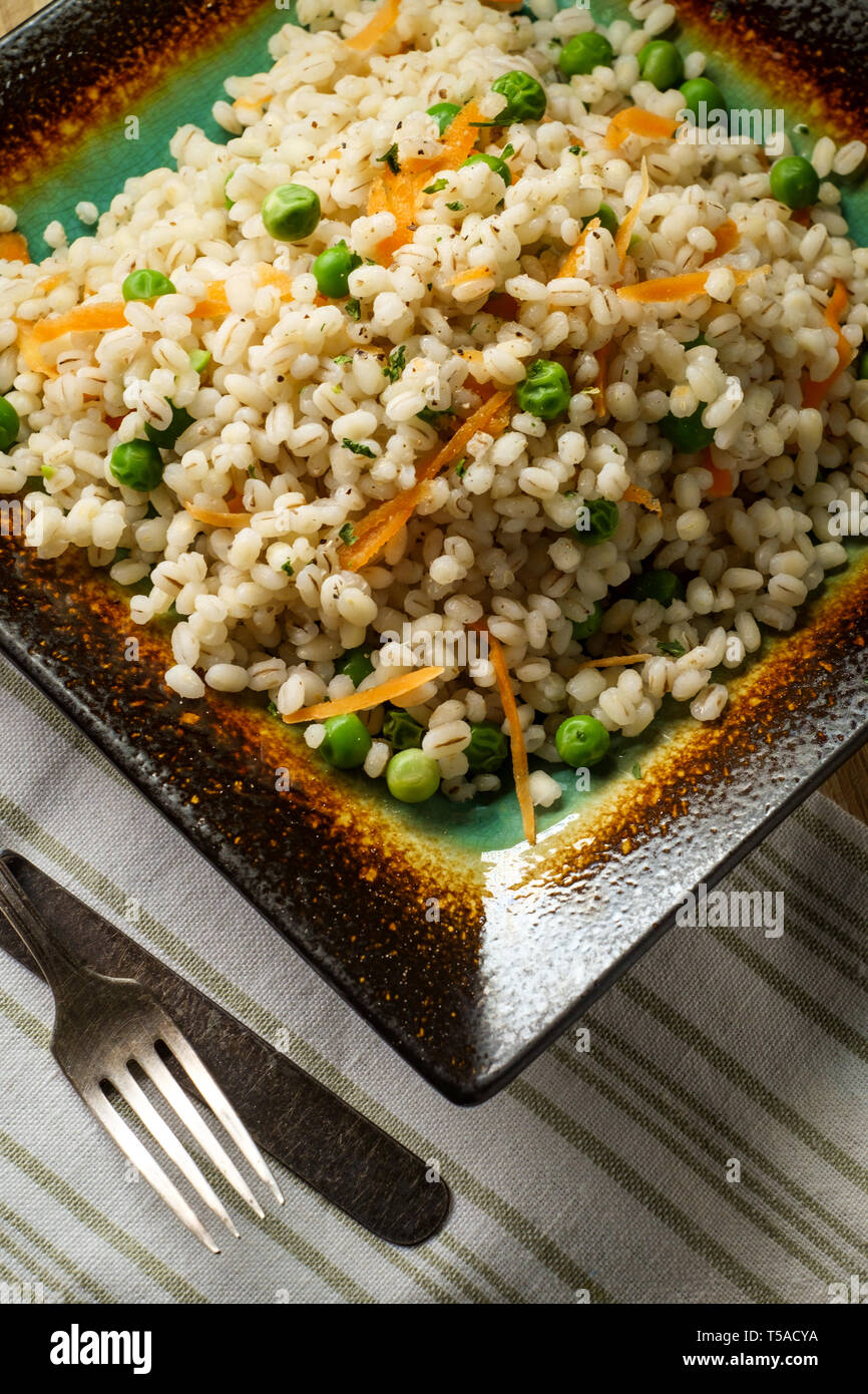 Cooked pearled barley porridge with green peas and grated carrots Stock Photo Alamy