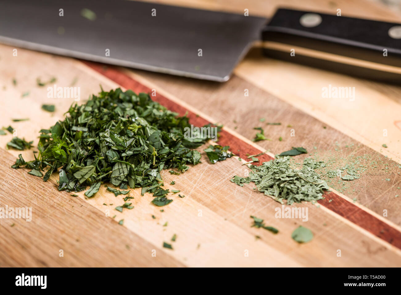 Chopped fresh and dried oregano ready to use in homemade pizza sauce Stock Photo