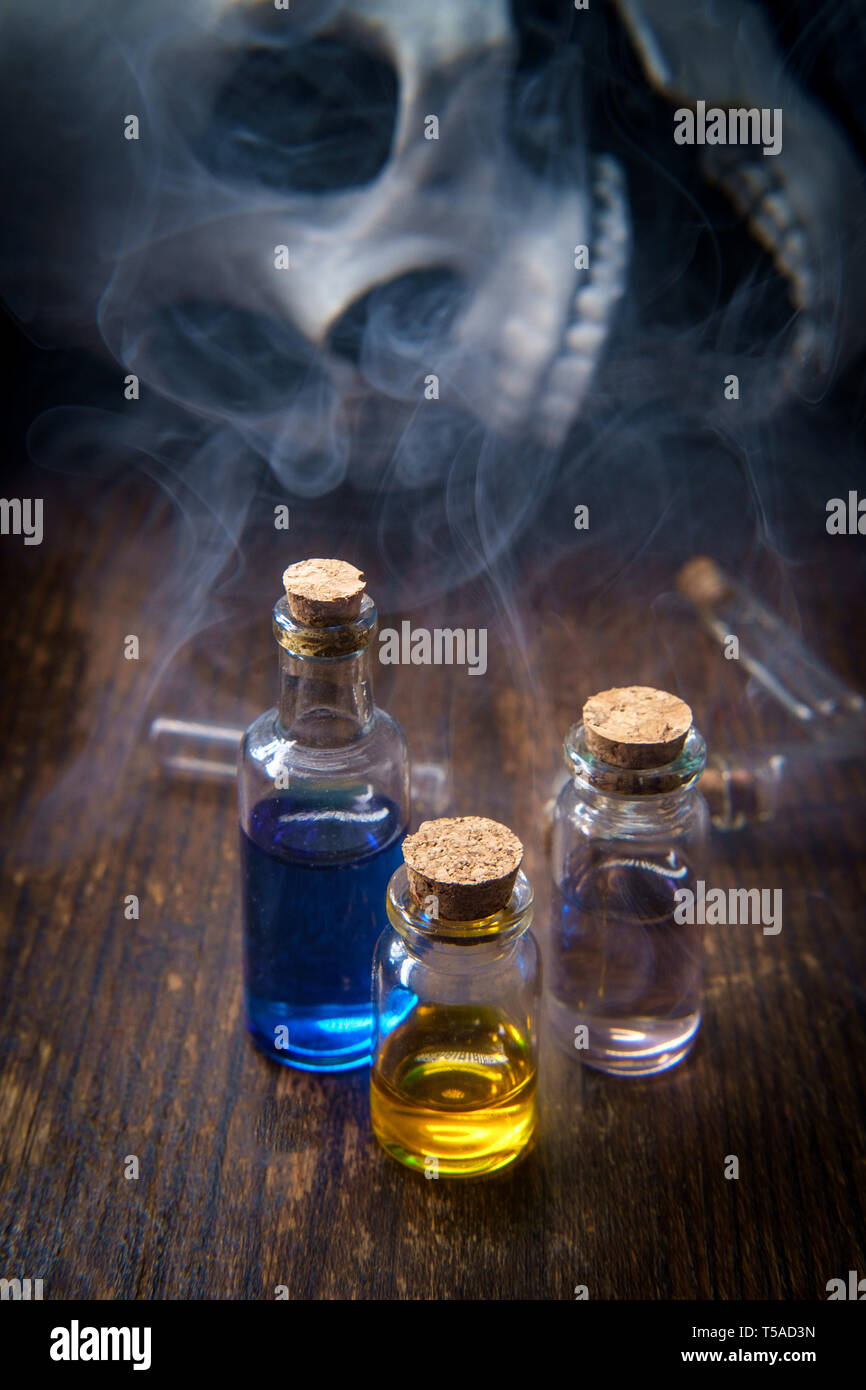 Witches magic potion poison bottles with vapors and human skull Stock ...