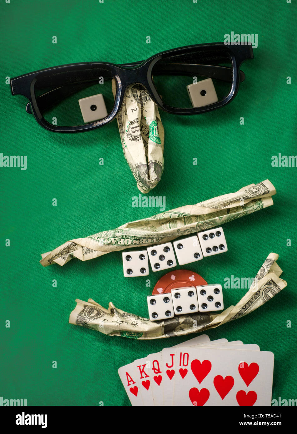 Silly bad poker face metaphor made from various gambling items including  money dice cards and poker chips Stock Photo - Alamy