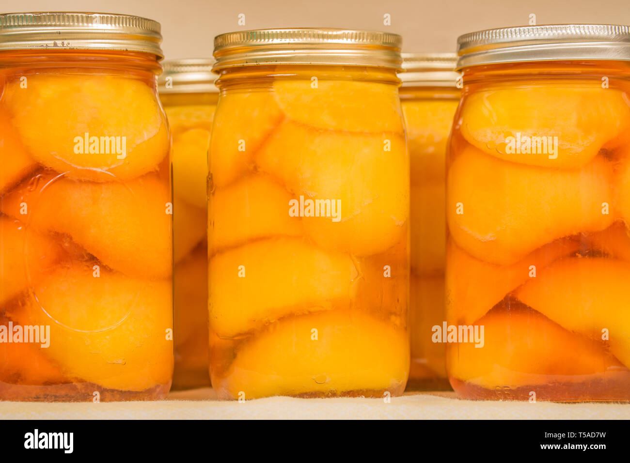 Freshly canned jars of peaches on a shelf Stock Photo Alamy