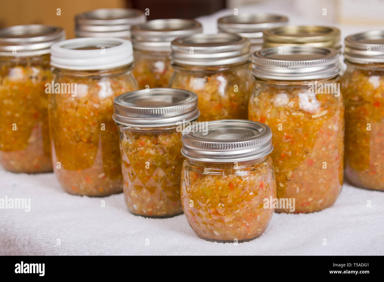 Group of relish jars of various sizes, ready to be parboiled Stock