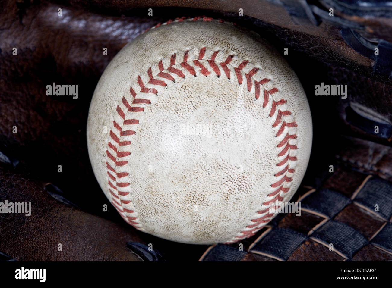 Close up of Used baseball inside a baseball glove isolated on white ...