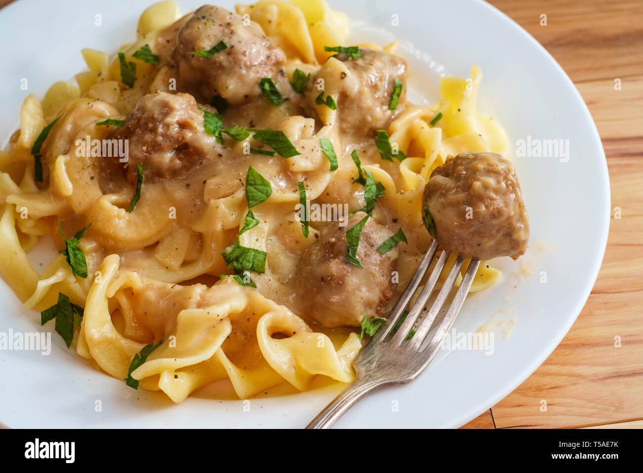 Swedish meatballs in creamy gravy with curly egg noodles and parsley