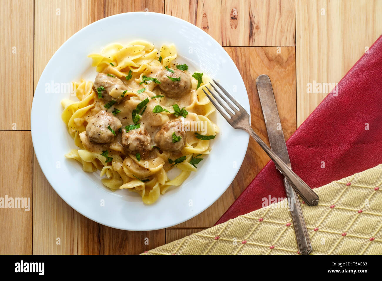 Swedish meatballs in creamy gravy with curly egg noodles and parsley