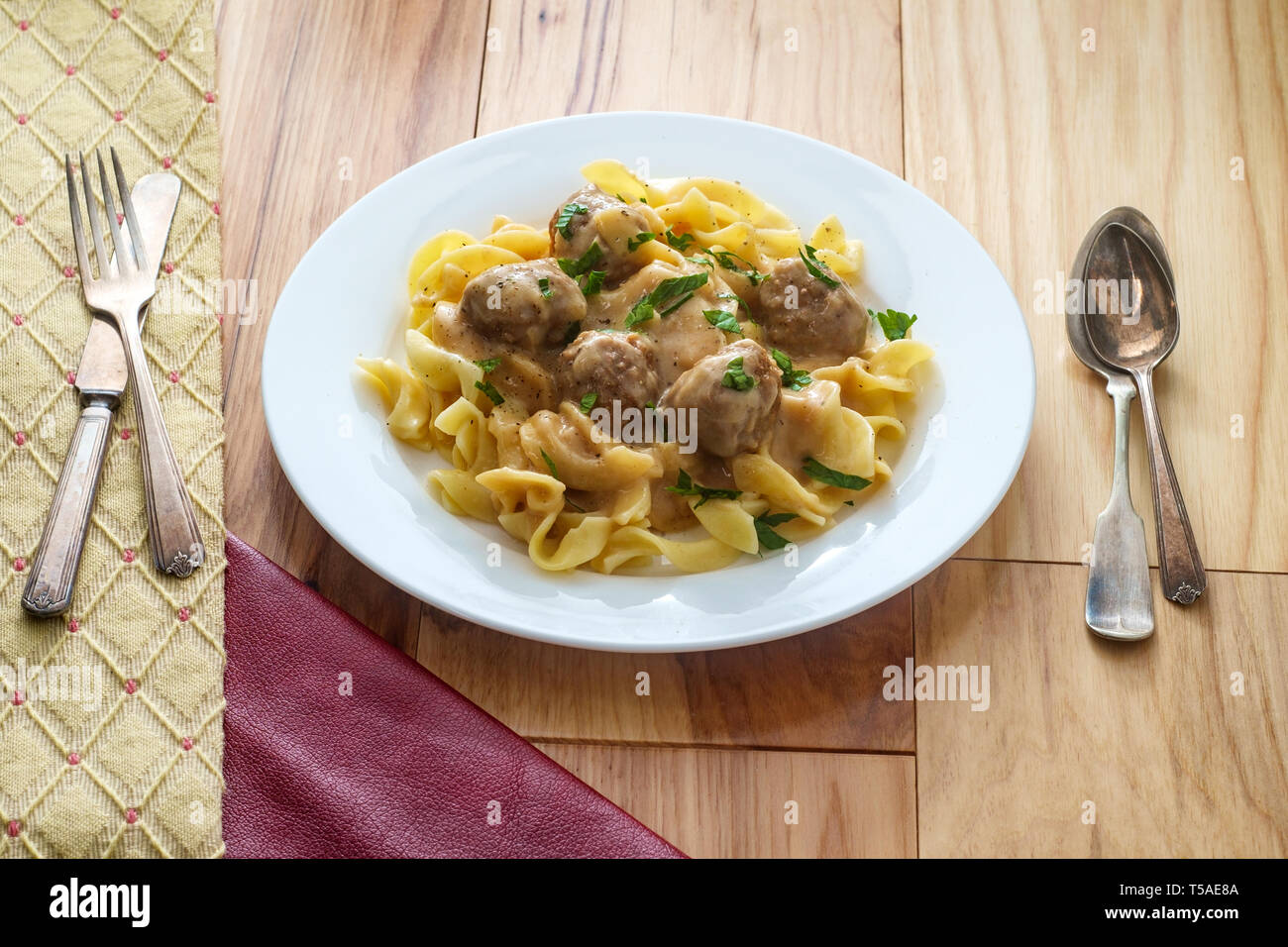Swedish meatballs in creamy gravy with curly egg noodles and parsley