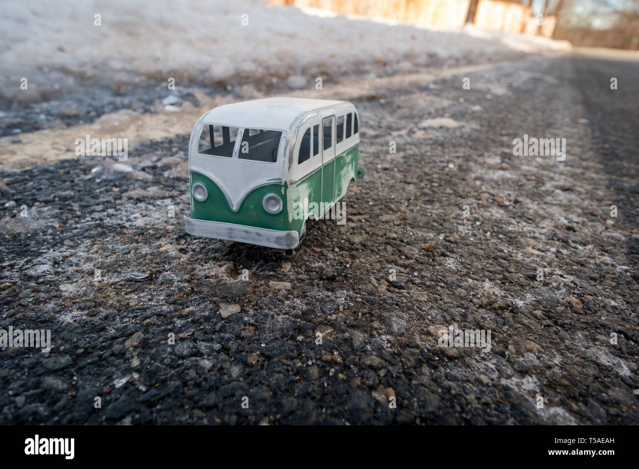 Antique toy hippie van harsh winter weather with snow and ice Stock