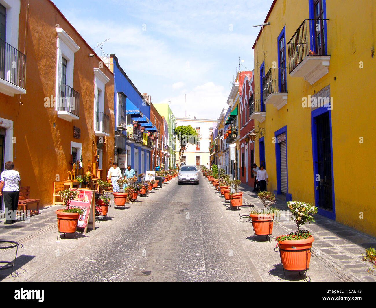 MERIDA, MEXICO 11 th March 2016: Street scene with colorful traditional old houses and old cars on street in Merida on hot sunny day. Big colonial cit Stock Photo