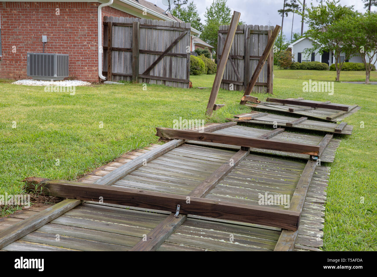 Fence damaged and blown down during severe weather Stock Photo