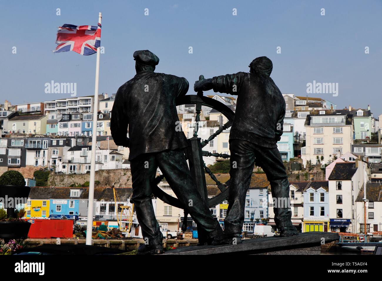 A statue to honour those lost at sea overlooks Brixham Harbour. Brixham, Devon, UK Stock Photo