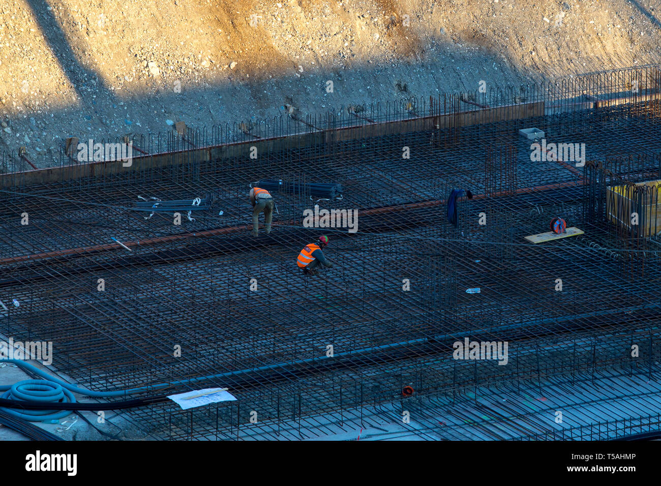 Construction of the building. Unrecognizable workers make metal ...