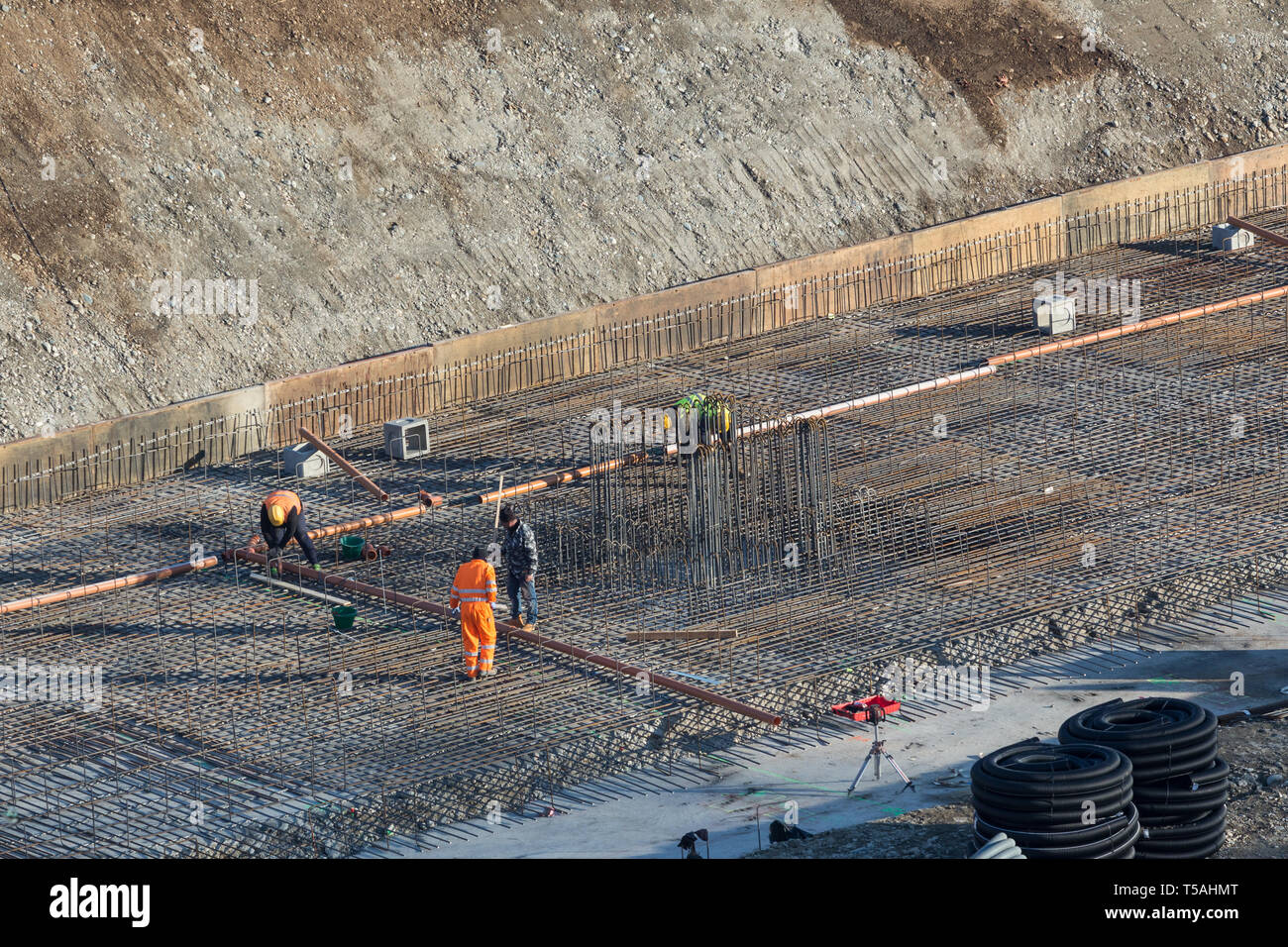 Construction of the building. Workers unrecognizable make metal ...