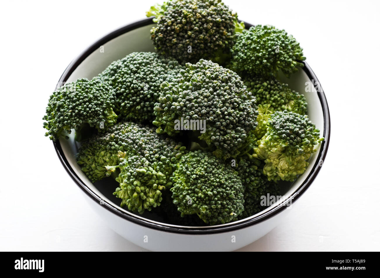 Image of organic  broccoli florets in the  ceramic bowl.Healthy eating concept. Stock Photo