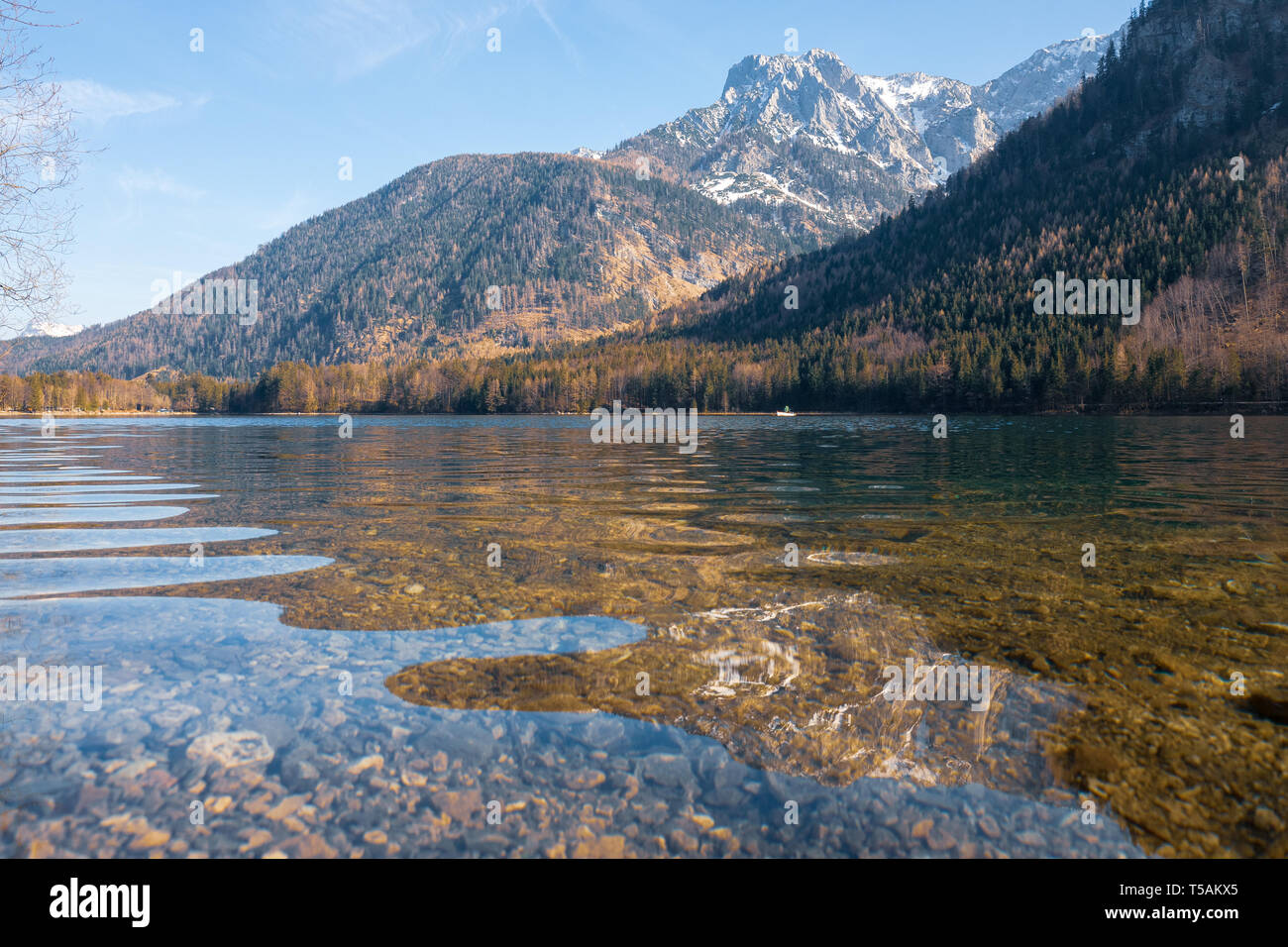 Scenic view of the great landscape reflecting on the shallow crystal clear water of the Vorderer Langbathsee near Ebensee, Oberösterreich, Austria Stock Photo
