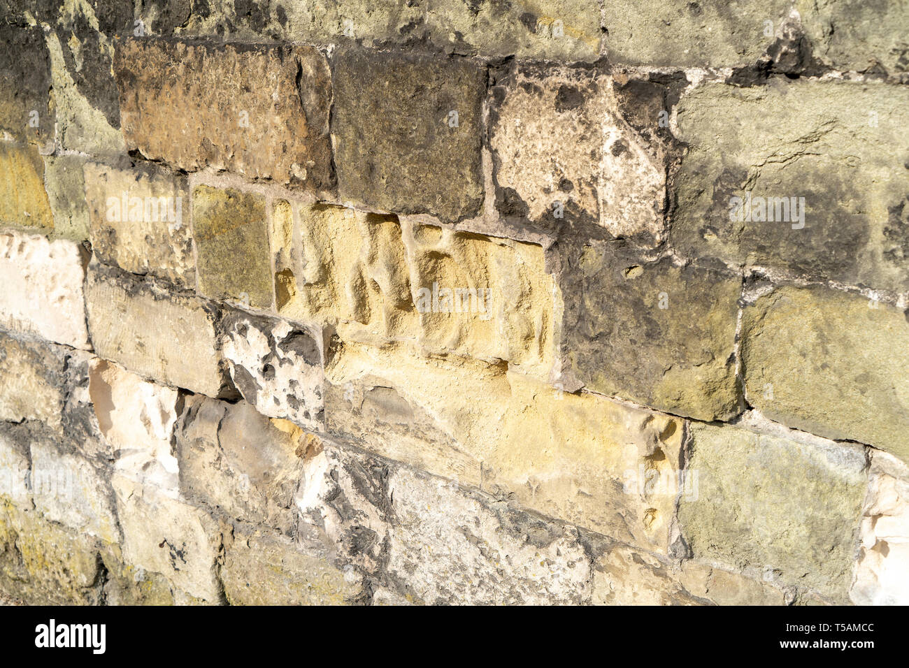 Erosion of stone blocks in a wall Stock Photo