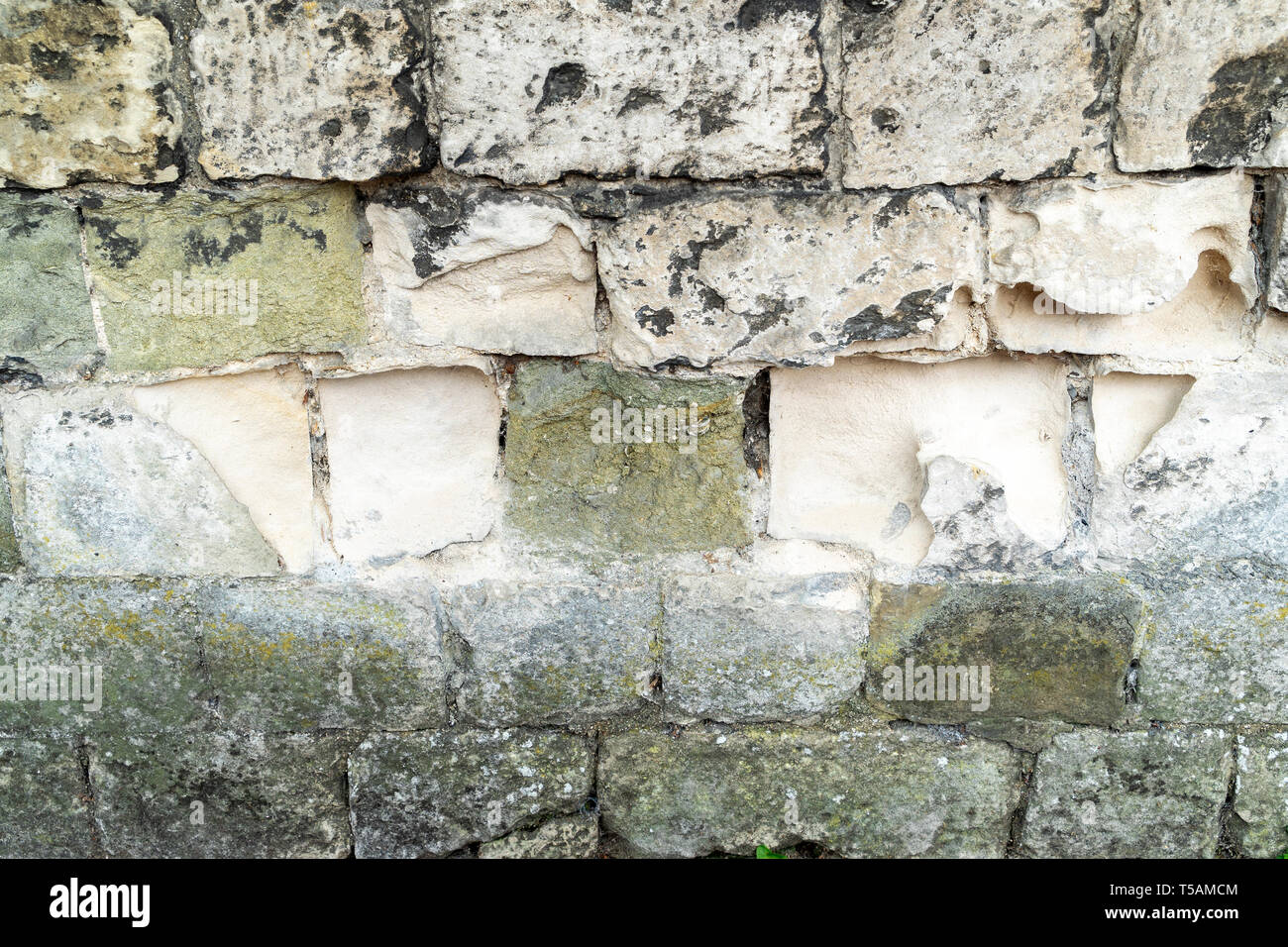 Erosion of stone blocks in a wall Stock Photo