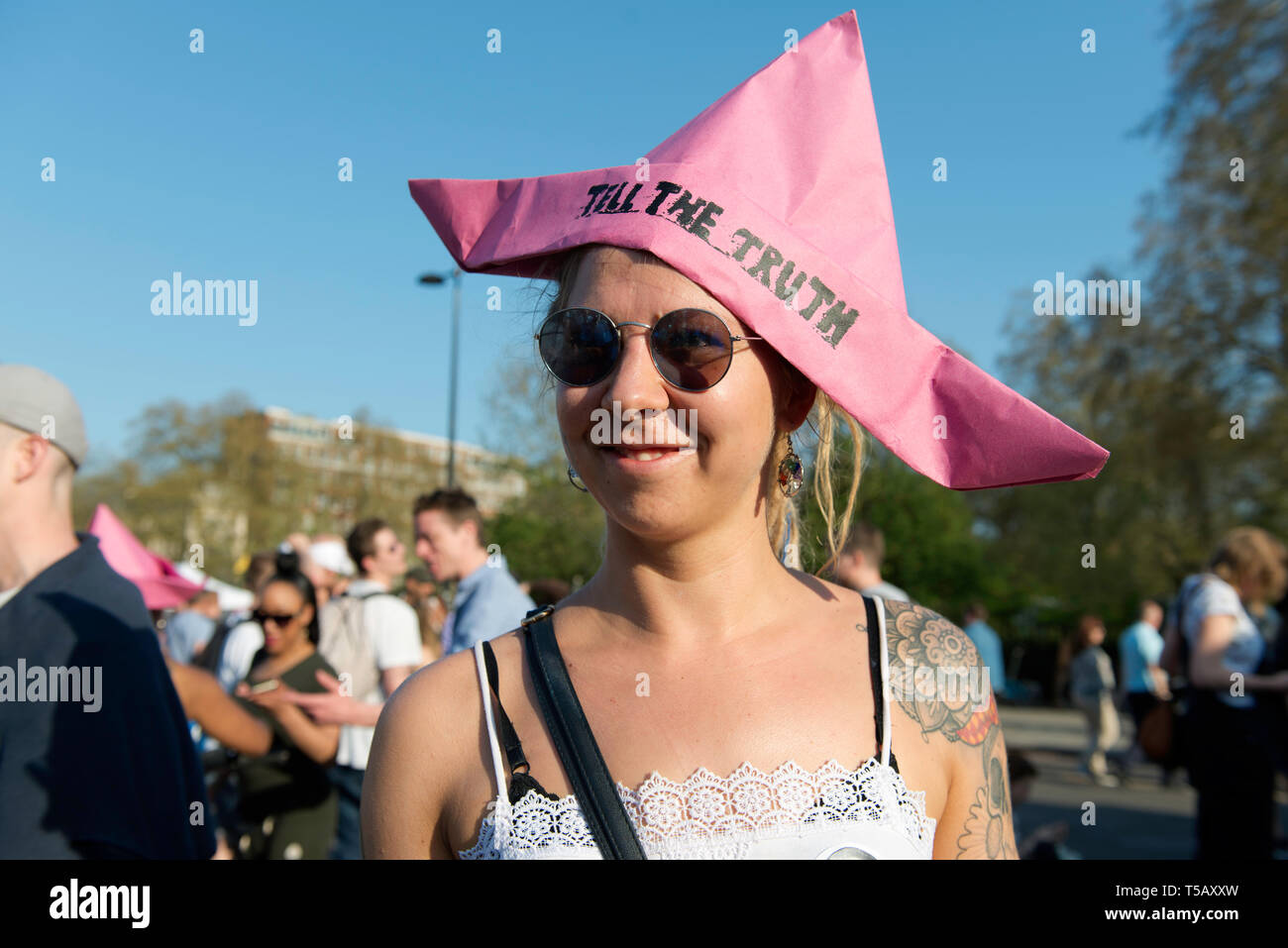 An activist is seen wearing a pink paper hat emulating the Berta Cáceres boat that was removed from Oxford Circus during the protest. Climate change activists from the Extinction Rebellion camped at the Marble Arch in central London where all their activities such as music, artwork and classes are taking place from, after police officers cleared sites at the Oxford Circus, Waterloo Bridge and Parliament Square from Extinction Rebellion protesters. Extinction Rebellion demands the government for direct actions on the climate and to reduce carbon emissions to zero by 2025 and also the people’s a Stock Photo