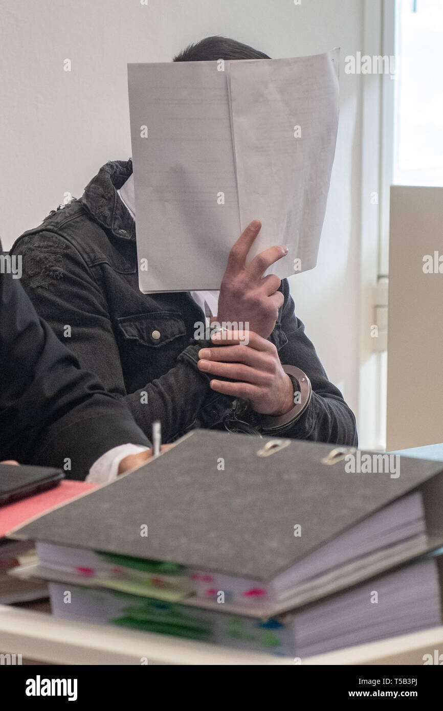 Amberg, Germany. 23rd Apr, 2019. One in four defendants enters the hearing room of the District Court of Amberg. Four young refugees have to answer in court because at the end of last year they allegedly attacked indiscriminately passers-by in the city centre of Amberg. Credit: Armin Weigel/dpa - ATTENTION: person(s) was/are pixelated for legal reasons/dpa/Alamy Live News Stock Photo
