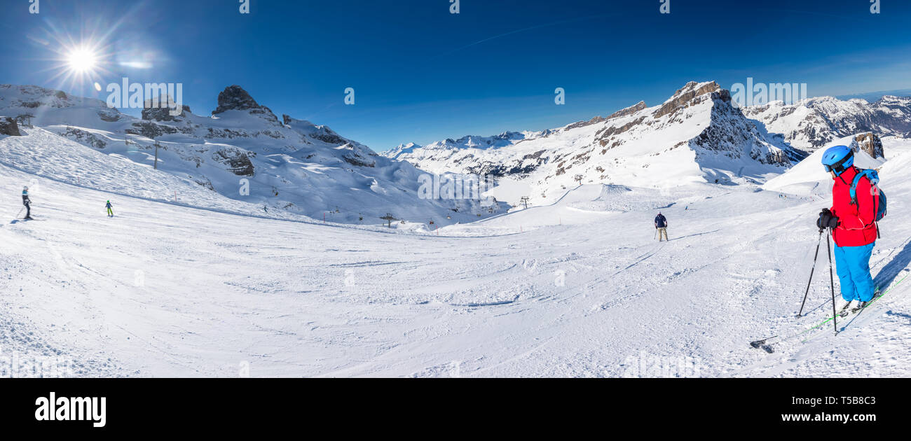 Beautiful winter landscape with Swiss Alps. Skiers skiing in famous Engelgerg - Titlis ski resort, Switzerland, Europe. Stock Photo