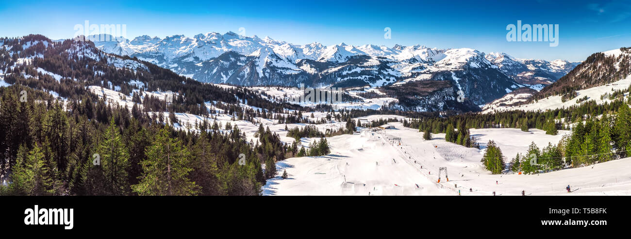 Beautiful winter landscape. People skiing in Mythenregion ski resort, Ibergeregg, Switzerland, Europe. Stock Photo