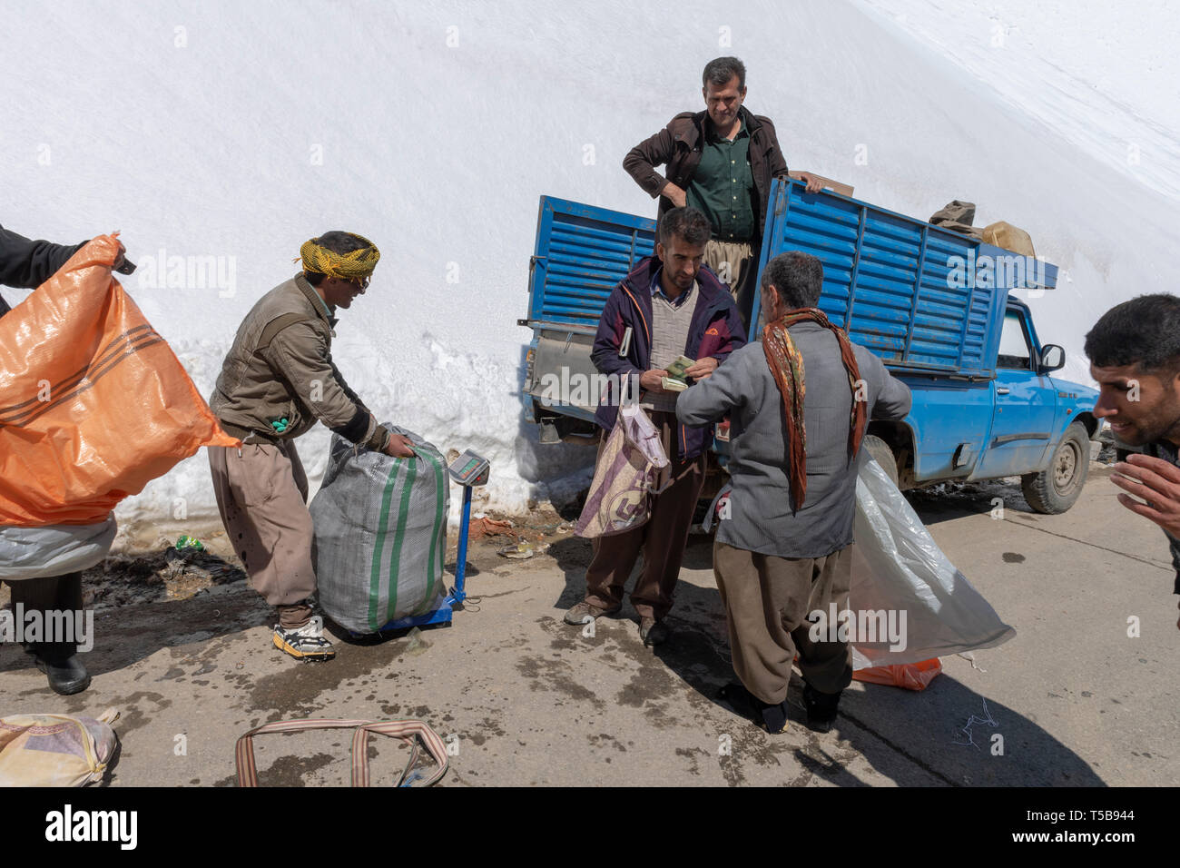 Couriers Loading Truck In Uraman Valley in Winter, Kurdistan Province, Iran Stock Photo