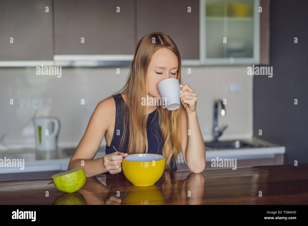Beautiful woman having coffee and fruits for breakfast Stock Photo Alamy