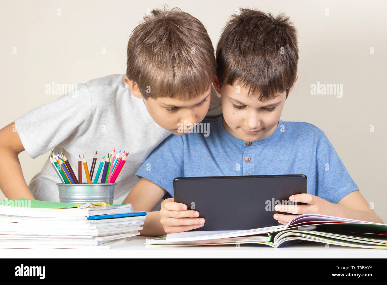 Kids using together tablet computer at home Stock Photo