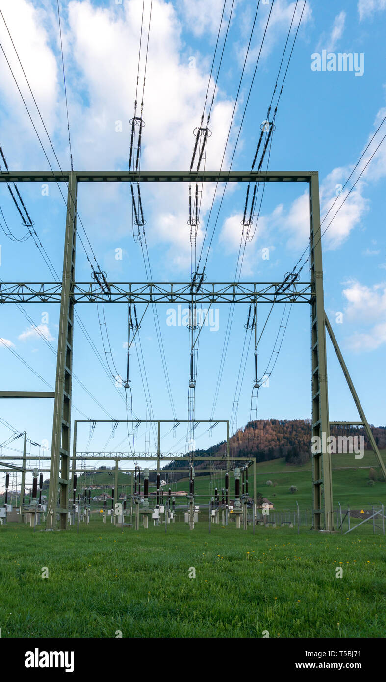 vertical view of a large high voltage power station in the hills of