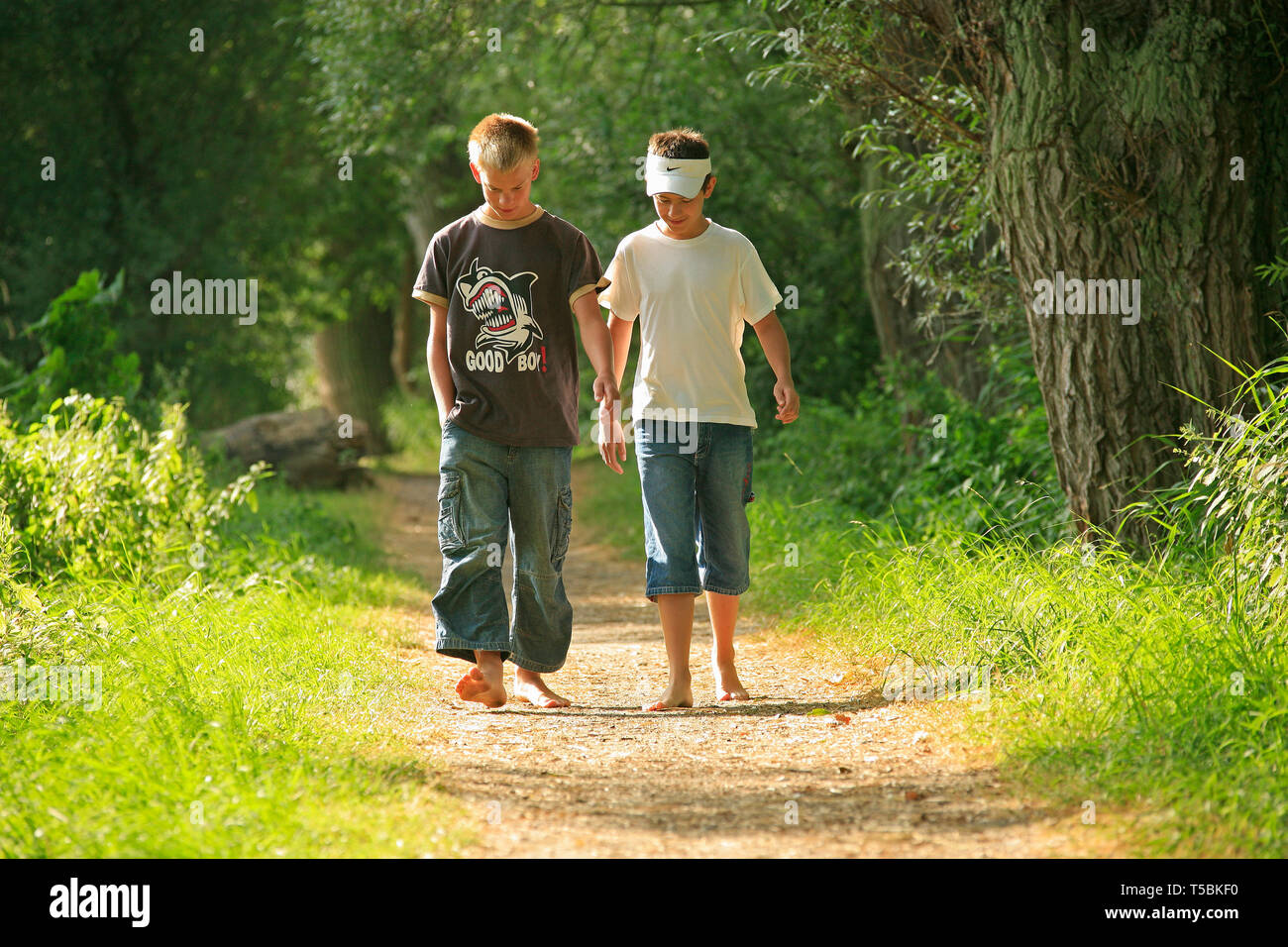 barefoot boys walking along a forest path Stock Photo - Alamy