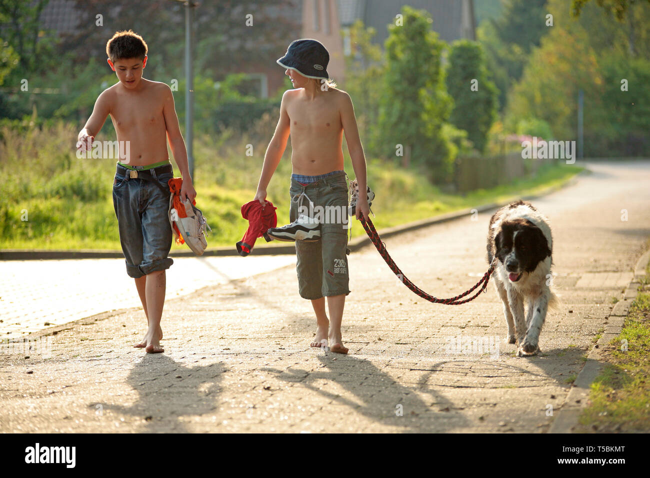 barefoot boys walking their dog Stock Photo - Alamy