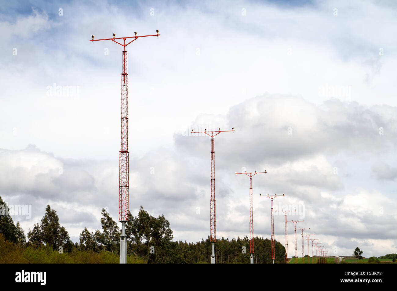 Airport landing light tower against cloudy sky. Airport security equipment Stock Photo