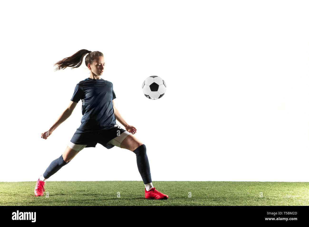 Young Female Football Or Soccer Player With Long Hair In Sportwear