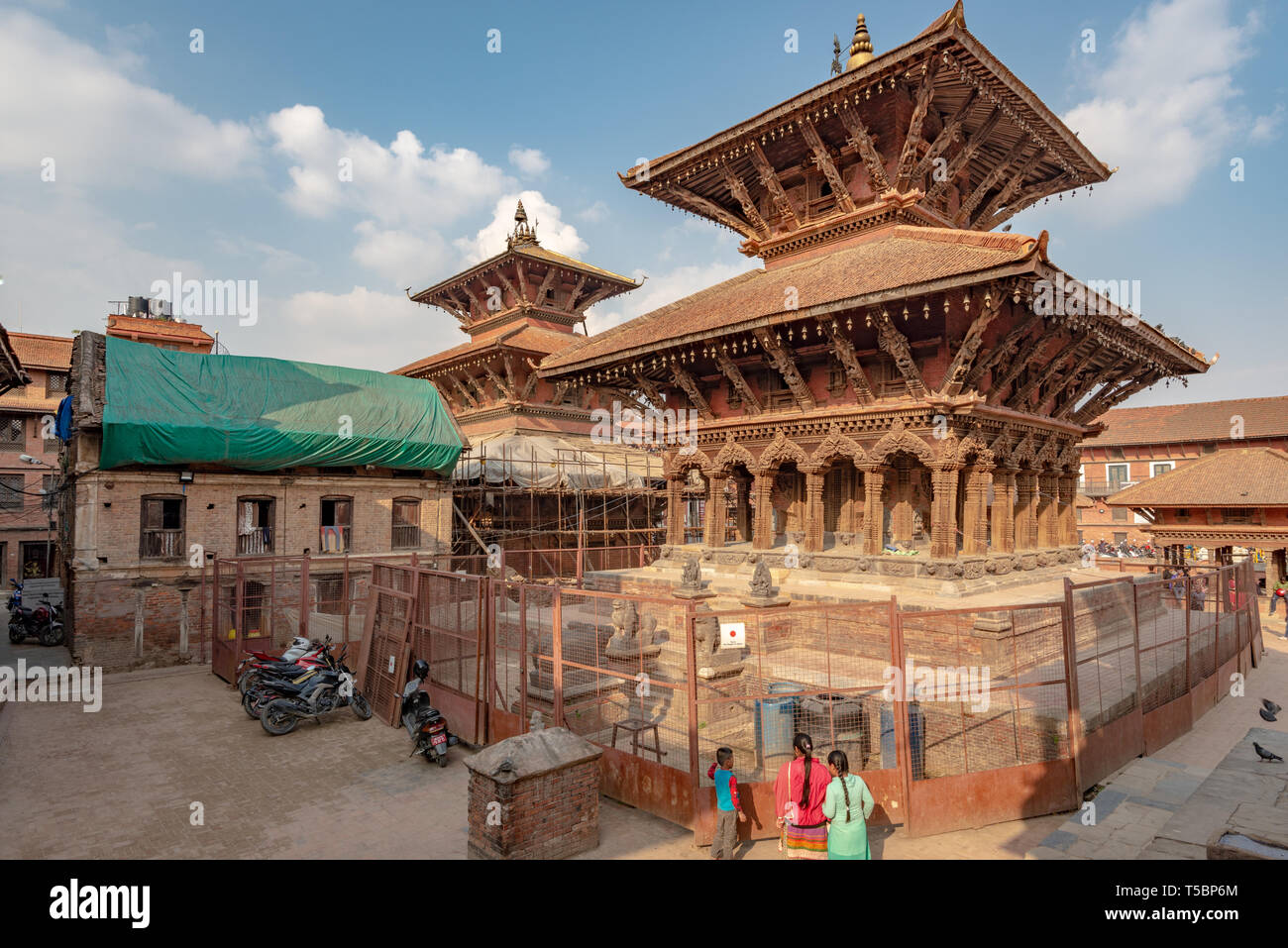 LALITPUR, PATAN, NEPAL - APRIL 3, 2019: Two temples in reconstruction after the 2015 earthquake on the Durbar Square of Patan Stock Photo